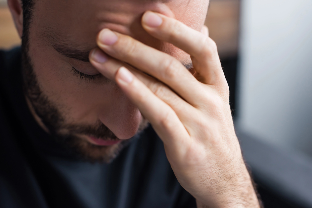 Male Holding Head Feeling Unwell