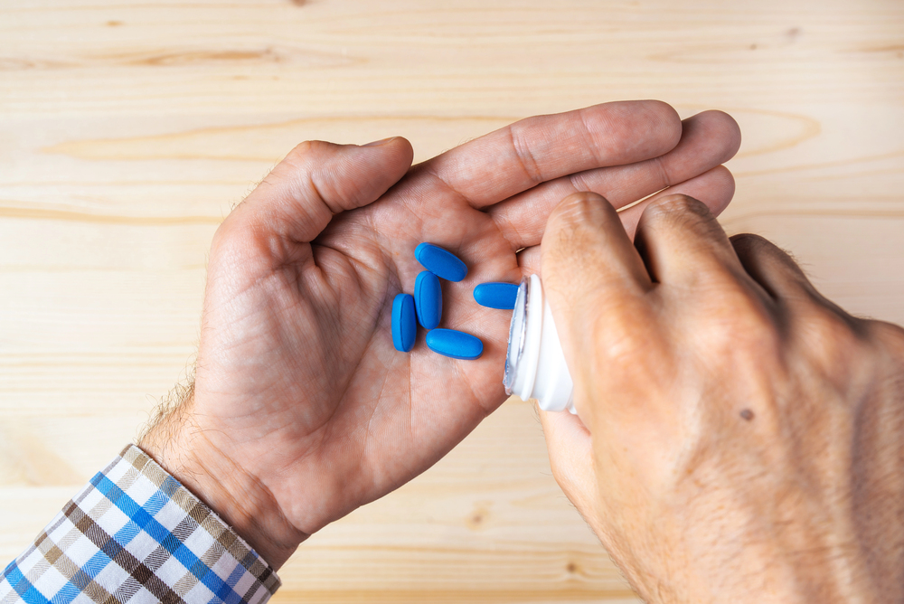 Male Holding Blue Pills