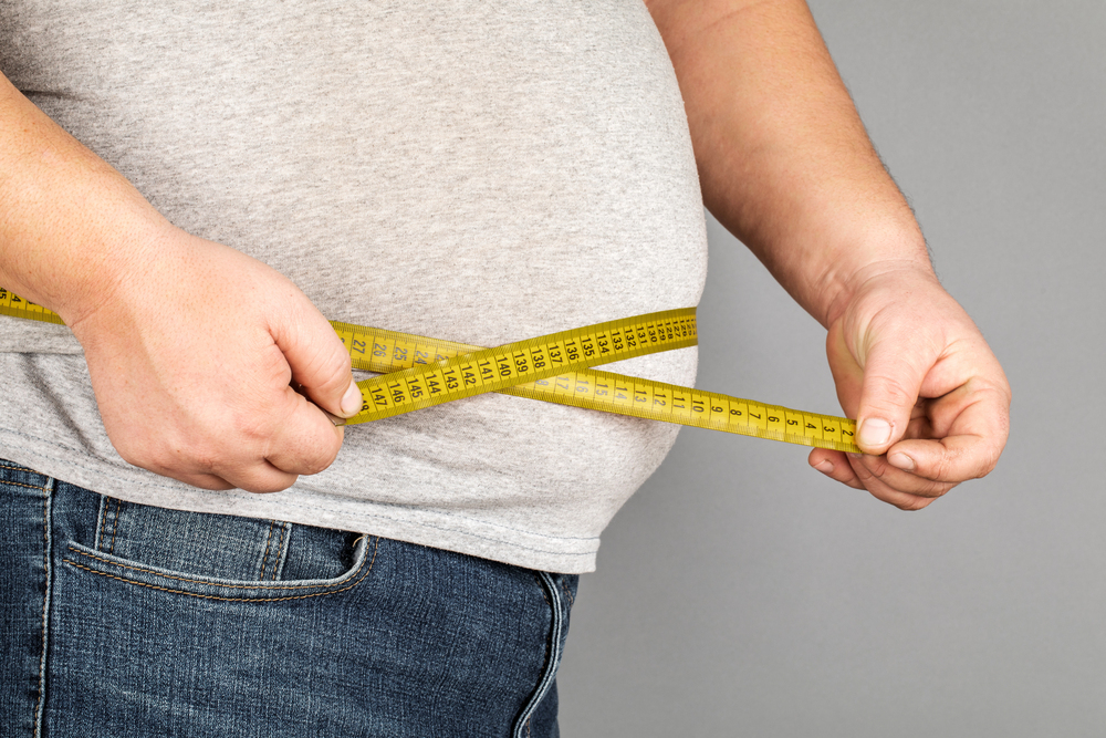 Man measuring his stomach