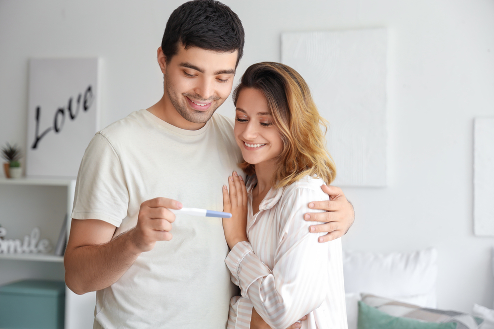 Man and Woman Looking at a Pregnancy Test