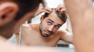 Man Inspecting Hair Growth